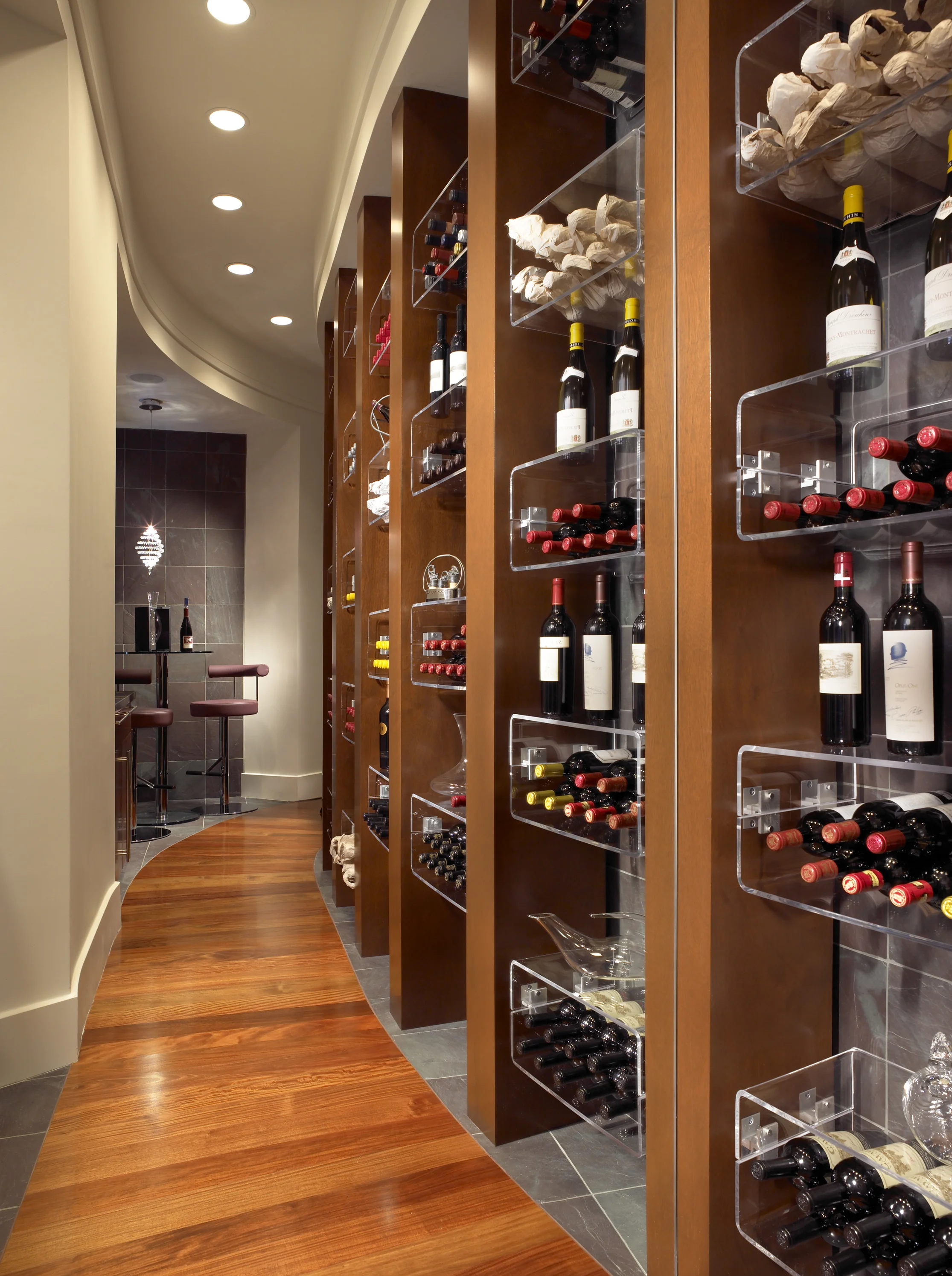 Custom wine-room cabinetry with integrated storage and detailed wood finishes.